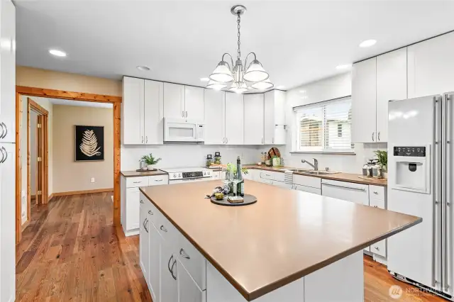 Bright inviting country kitchen is heart of home w/living room on one side & semi-formal dining on the other