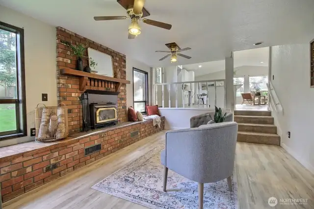 Lower level family room with brick fireplace and woodstove insert.