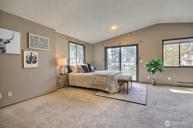 Primary suite featuring vaulted ceilings, not 2, but 3 closets, & updated ensuite, bath.