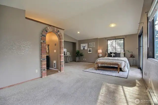 Primary bedroom is large enough for a king size bed and sitting area.