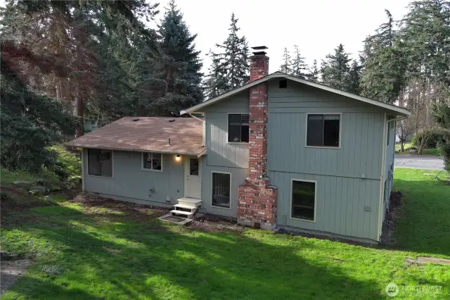 The expansive backyard offers endless possibilities for entertaining, gardening, or relaxing in privacy.