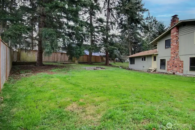 Plenty of room to garden, play, or host summer BBQs on this .27-acre private lot!