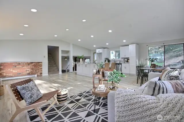 Step inside to find a beautifully updated kitchen, featuring a massive island perfect for entertaining, gleaming quartz countertops, stainless-steel appliances, and new, modern cabinetry.