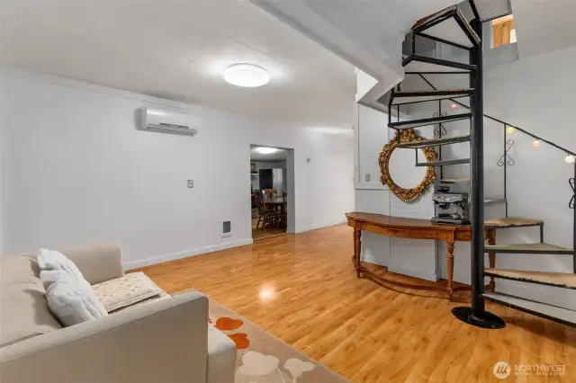 Looking from the primary bedroom area toward the living room and kitchen (which is through the opening in the middle of this photo). Ductless heat pump helps for more efficient heating and cooling.