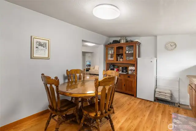 This is a large eating table that fits comfortably in the kitchen.