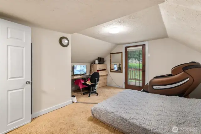 The other upstairs room with door to the upper deck looking out over the property.