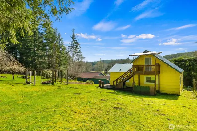 The backside of the home with it's deck off of the upstairs room.