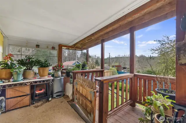 The front porch/deck has a great view looking over the lower acreage.