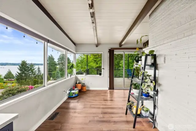 Dining nook features corner windows offering uninterrupted view and natural lighting
