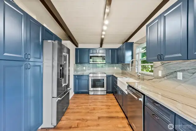 Well appointed Kitchen with Modern Appliances, pull out Trash Drawer Cabinet, and Wood Burning Pizza Oven tucked into the back of the fireplace.