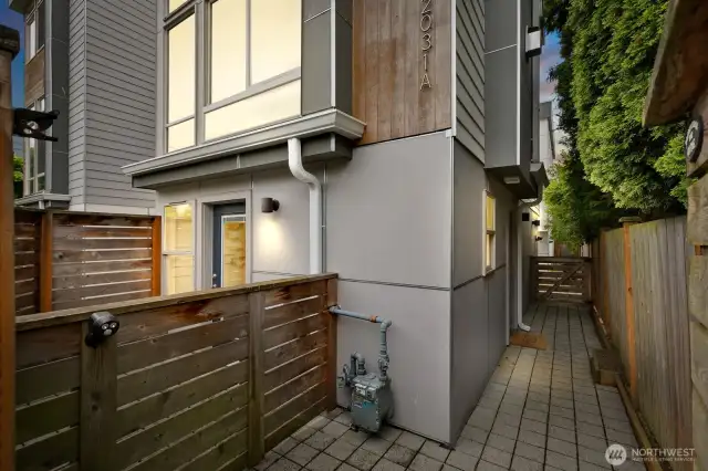 Enter on the west side of the home. The door pictured to the left is off of the lower level bedroom and leads to the enclosed patio.