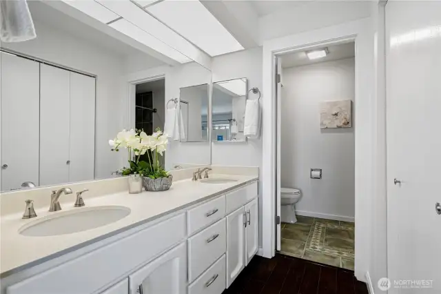 En-suite bathroom with double vanity and bathtub.