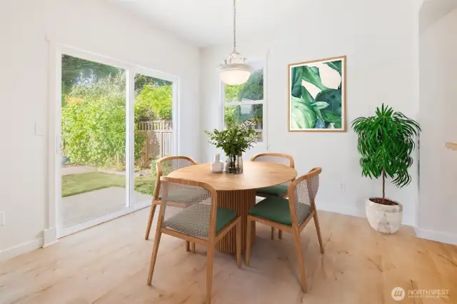 Eating area with slider to back porch and yard. (Virtually Staged)