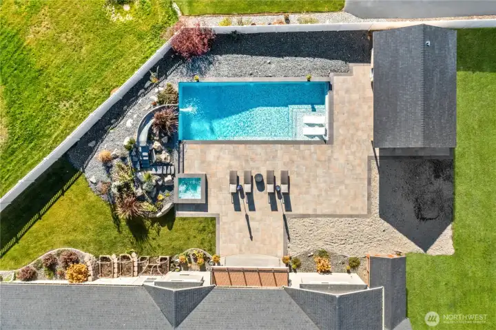 Step into your own private resort, featuring a sparkling in-ground pool, relaxing hot tub, and a stylish pool house surrounded by a beautifully landscaped setting