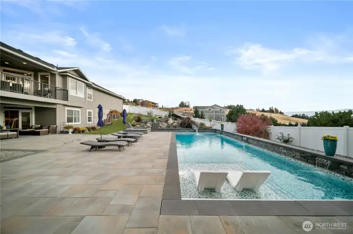 The pool features a sun-soaked Baja ledge—a shallow oasis made for lounging in the water, dipping your toes, and enjoying sunny afternoons in complete comfort