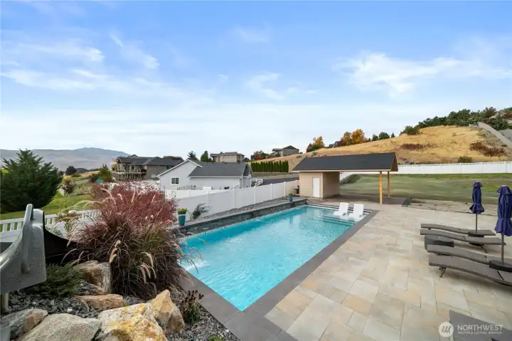 Pool house and plenty of space to lounge, dine, and unwind.  Features a half-bath and plumbed and plumbed for outdoor kitchen and wired for media