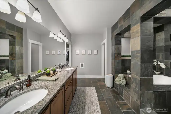 Elegant finishes, sleek dual sinks and refined design elements adorn the primary bath.