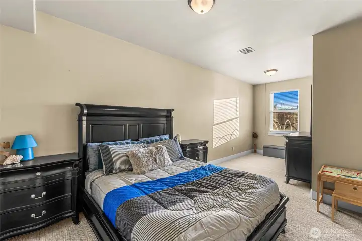 Bedroom 3 offers a welcoming guest retreat featuring soft natural light, timeless finishes, and ample space including a spacious walk-in closet.