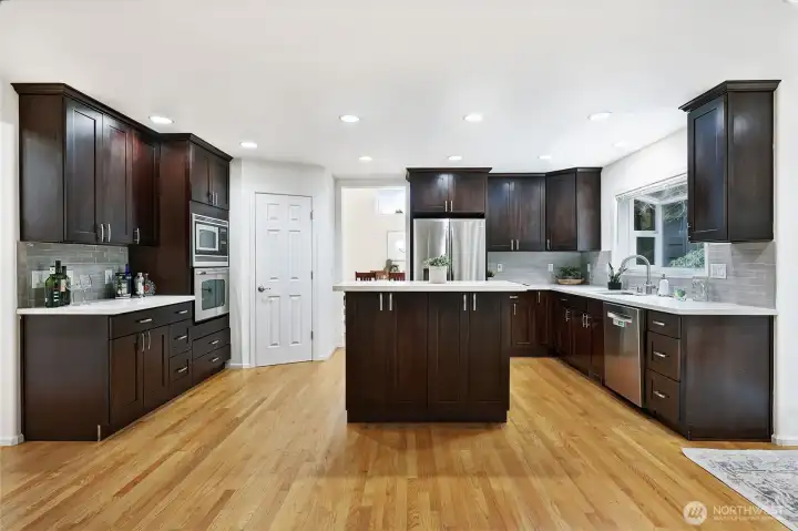Built-in stainless steel appliances blend seamlessly into the rich espresso cabinetry.