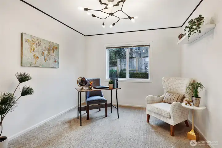 The main floor bedroom doubles as a quiet office space with bright artisan lighting.