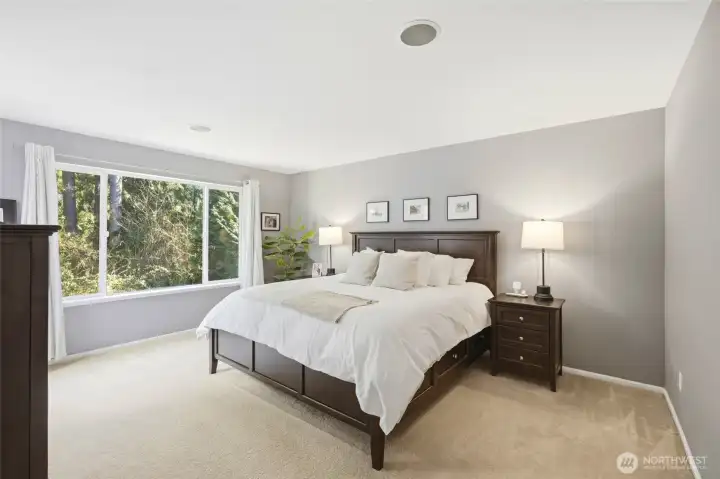 Primary suite overlooking greenbelt.