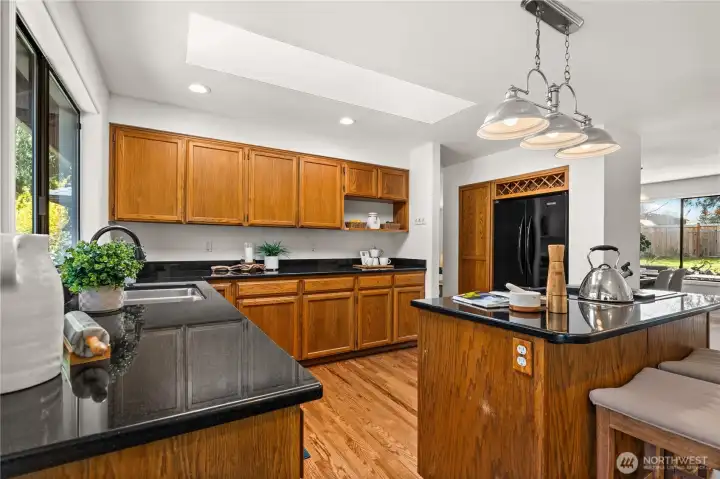 The kitchen features beautiful oak cabinetry and granite countertops.  New recessed lights have also been installed.