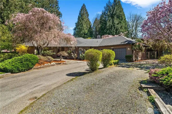 An additional driveway affords a place for more vehicle parking or recreation vehicles along the side of the house.