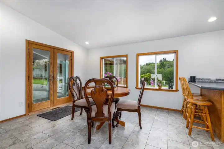 2nd dining area with French doors leading to the outdoor oasis