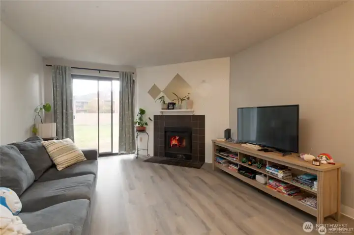 Cozy up in the living room with a classic wood-burning fireplace—perfect for relaxing evenings.