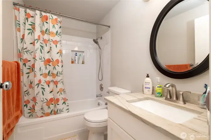 Newly remodeled primary bathroom with modern finishes; new cabinetry, shower and and a clean, updated design.
