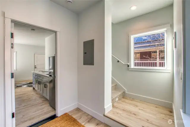 This is the second entrance from the parking area. The stairwell to the upper levels is accessible directly from the entry/mudroom. The door at left can be locked to create a private studio unit.