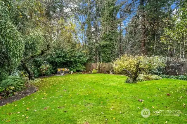 Park like back yard setting with mature landscaping, privacy and fully fenced