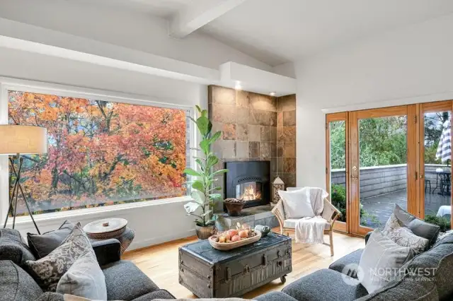 Picture window in the living room with gas fireplace with tile surround