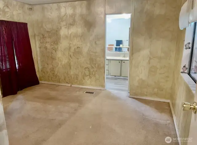 Primary bedroom looking into bathroom