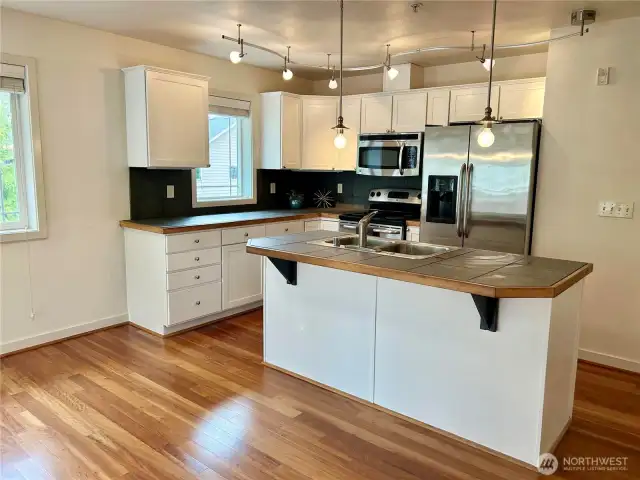 Open kitchen concept with white cabinets