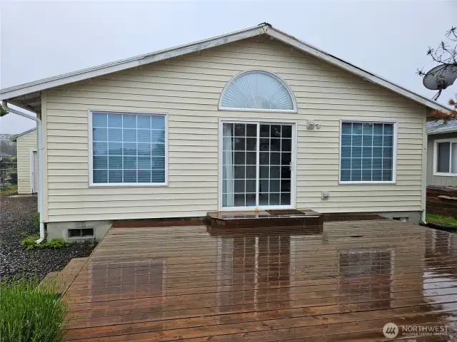 West facing deck with sliding door to dining are inside.