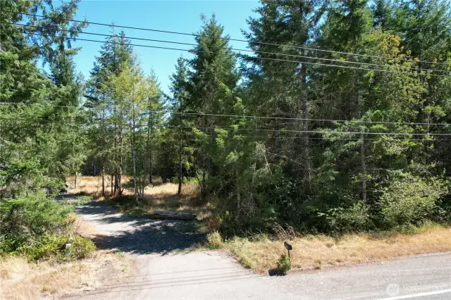 Easement road to the left goes to the neighbor. There is a pin towards the right showing the addtional 30' you can go to the left for htis road OR install a different entry