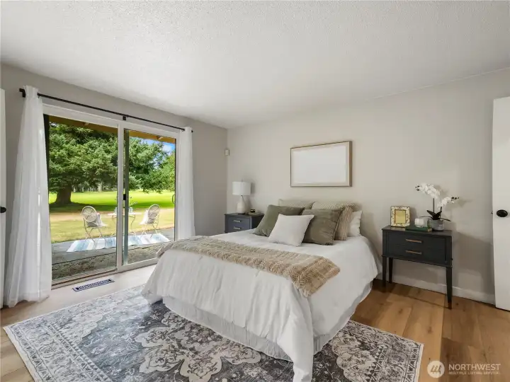 Primary bedroom with slider leading to the back patio...plenty of room for a hot tub!