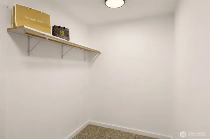 Primary bedroom walk in closet.