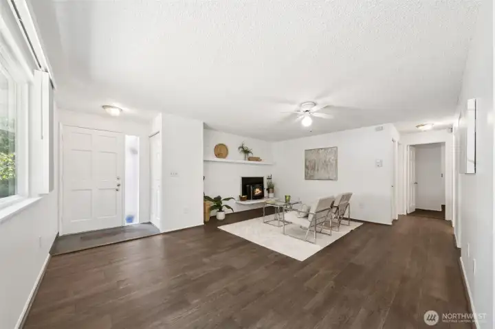 View of living area from kitchen nook.  Wood burning fireplace with insert and fully Tiled mantel