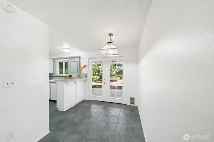 Kitchen nook with french doors that lead to a private covered pateo and yard.