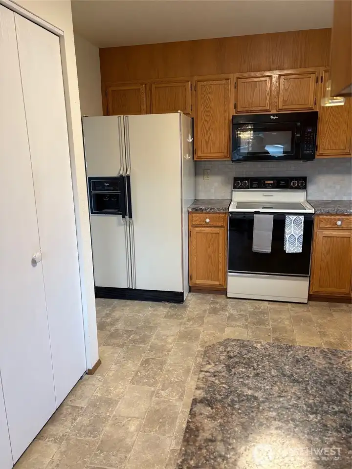 Kitchen with above stove microwave and pantry