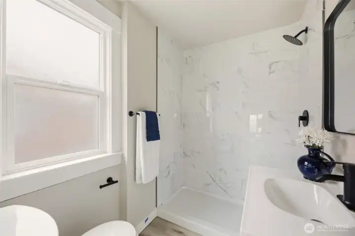 Three quarter bath off the primary is convenient and is complete with privacy glass that allows light, but privacy.