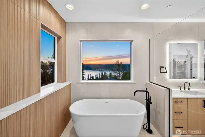 Enjoy picturesque Lake Sammamish views from your soaker tub through two windows. The primary bathroom layout provides ultimate privacy with breathtaking scenery.