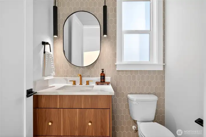 Main-level powder room offers comfort and sophistication. Conveniently located off the dining and living areas near the entry, it also features fantastic Lake Sammamish views.