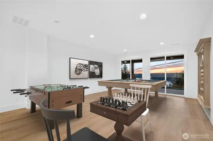 Lage rec room of kitchenet on lower level walking out to fully covered patio with breathtaking views of Lake Sammamish.