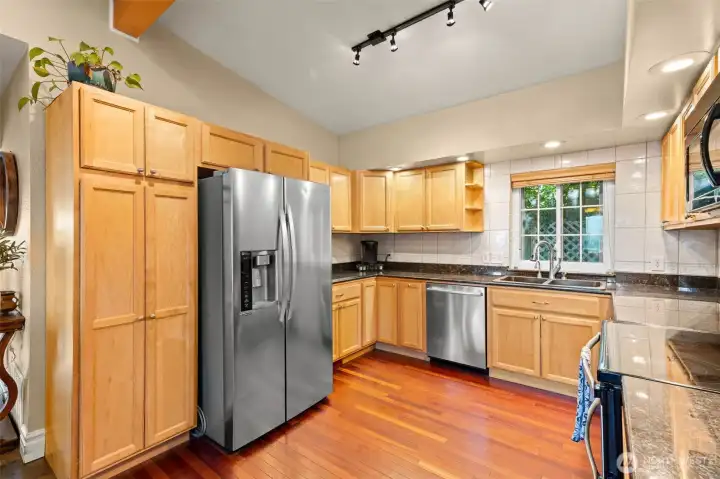 Kitchen provides generous counter sapce and storage options. Custom cabinets with lazy susans and other surprises. Top quality newer applinaces.