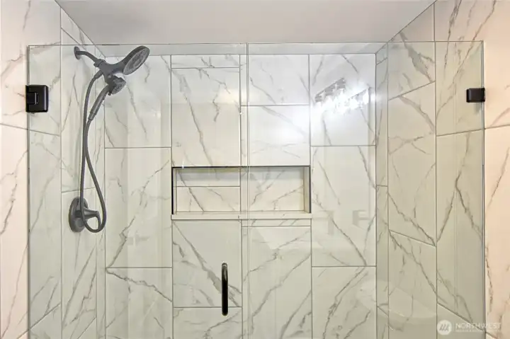Close up of the primary bathroom shower and enclosure