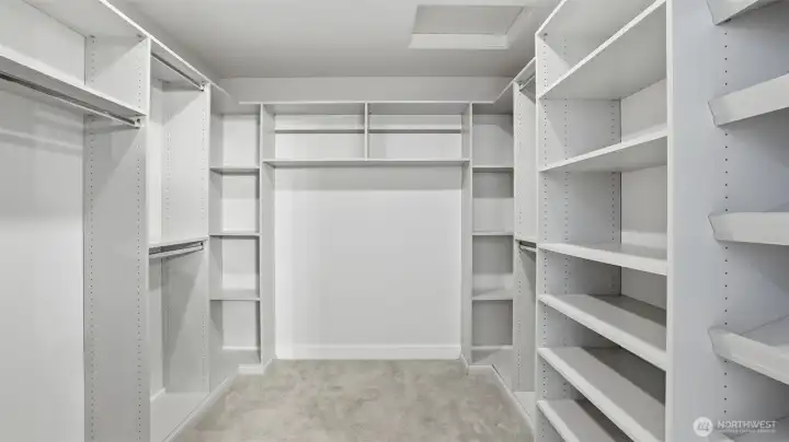 Expansive primary walk-in closet with custom built-ins and abundant storage.