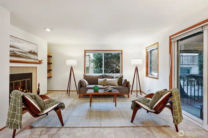 Spacious living room with wood burning fire place.
